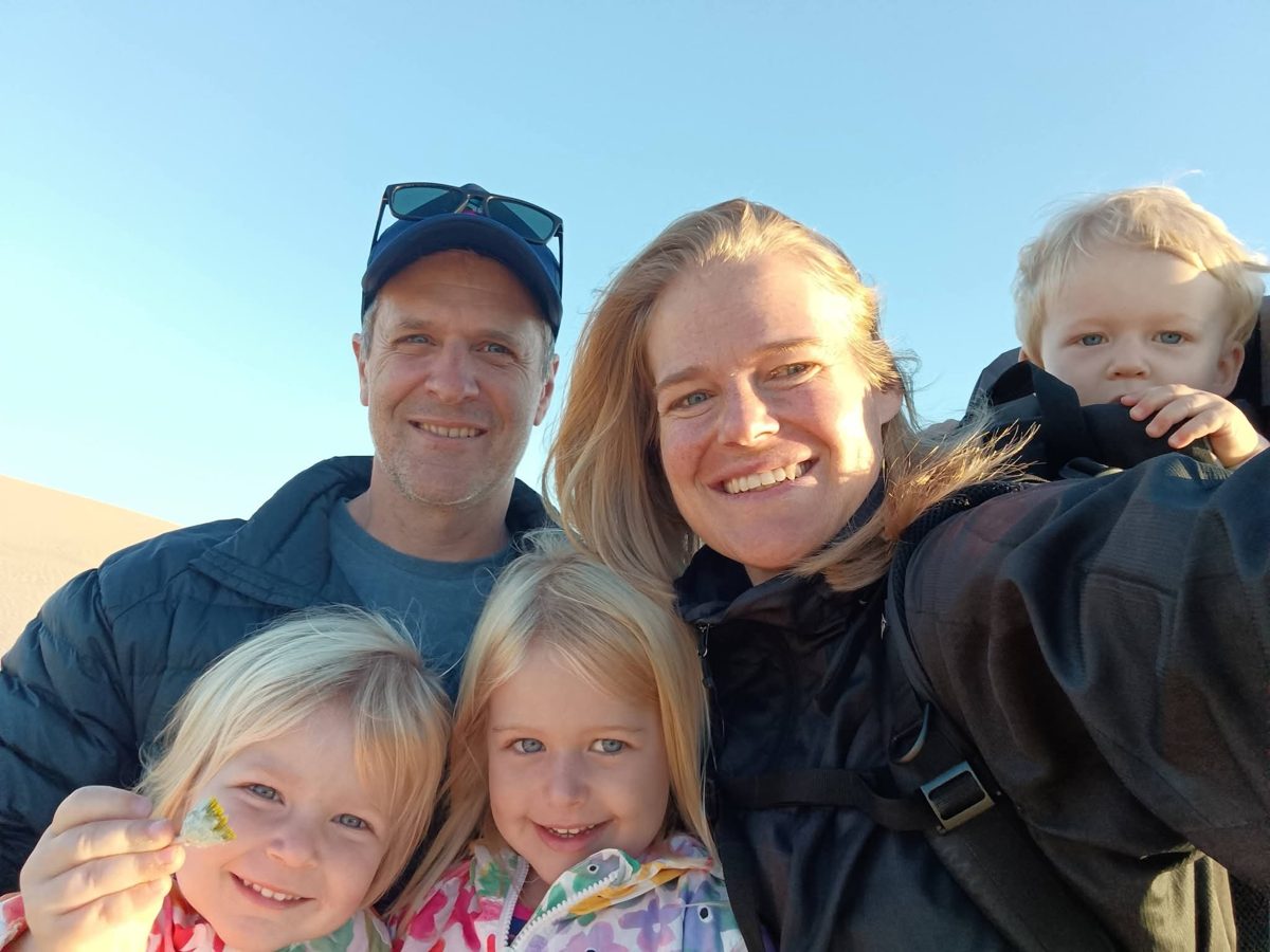 Dr Dean Wilson with his family on the beach