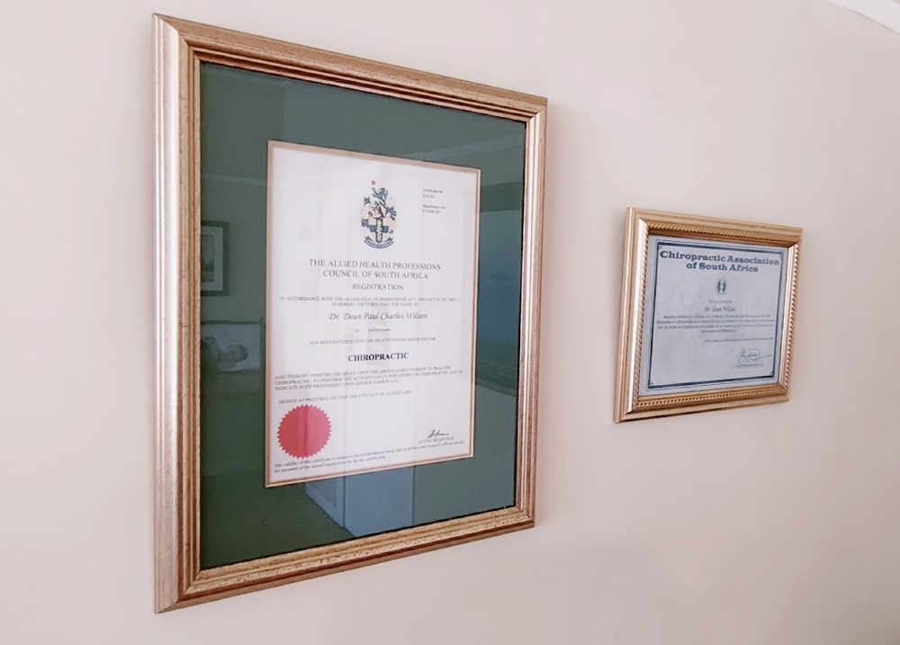Framed registration certificate from the Allied Health Professions Council of South Africa and Chiropractic Association of South Africa membership