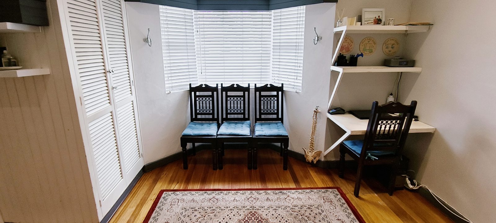 The treatment room at Wilson Chiropractic, with the bay window and waiting chairs